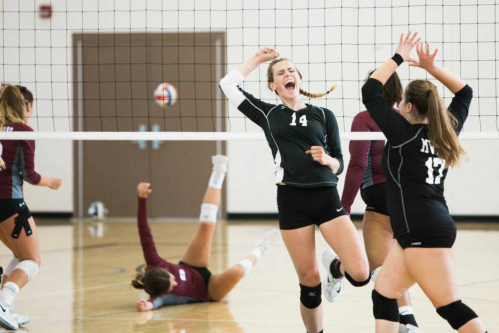 Women's volleyball team playing on an indoor court