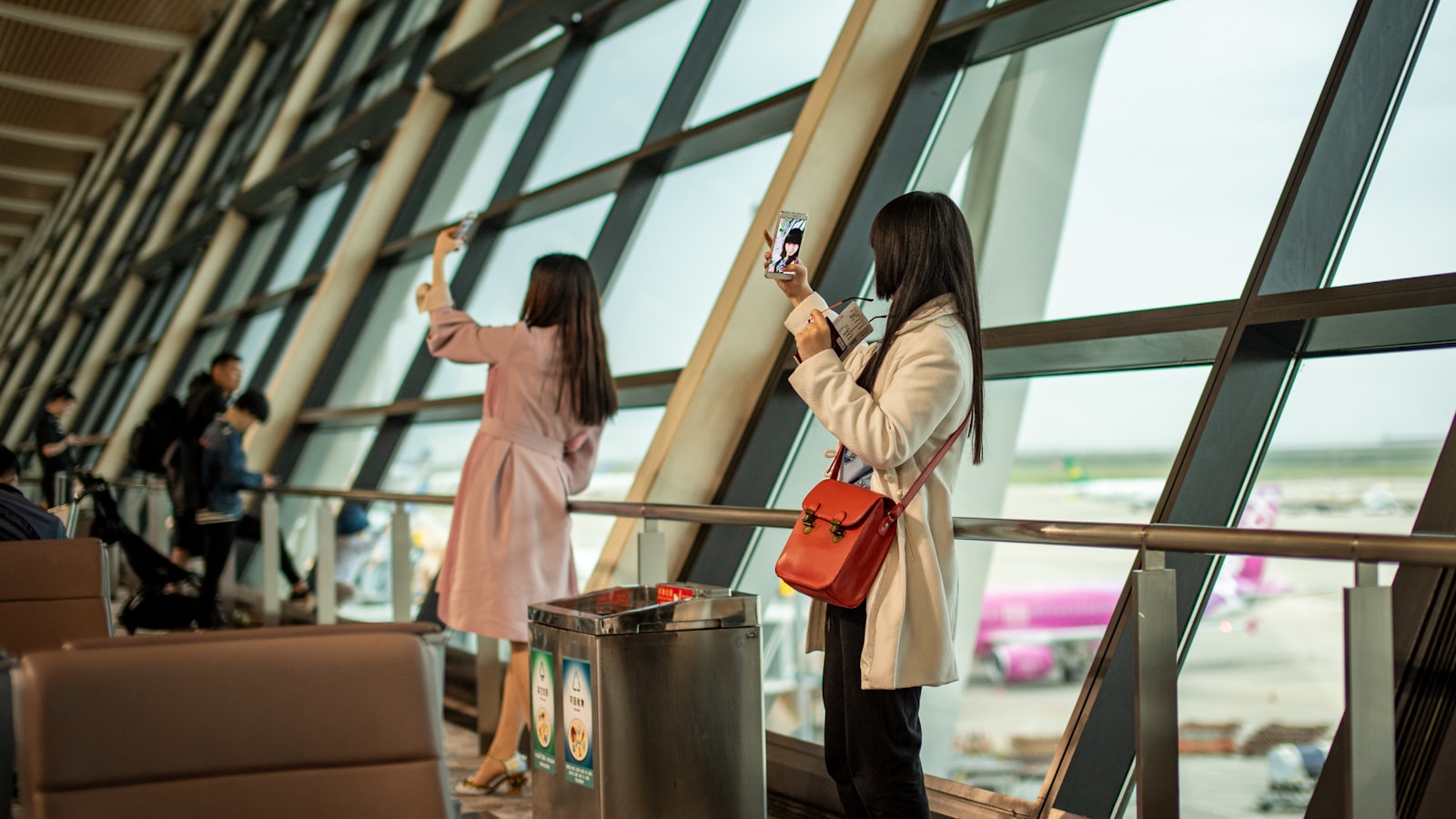 Travelers taking photos at an airport in China